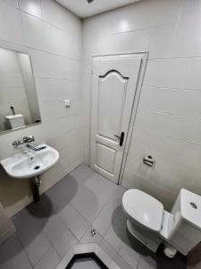 a bathroom with a toilet and a sink at Palma Beach Hotel in Kranevo +50 photos