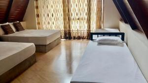 a room with two beds and a window at Coco Breeze Cabanas by Dr Aruna - Free Airport drop off or pick up 24H, free secure Luggage Holding in Katunayaka
