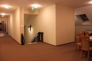 a hallway with a staircase and a table and chairs at Gościniec Legenda in Wyszogród +18 photos