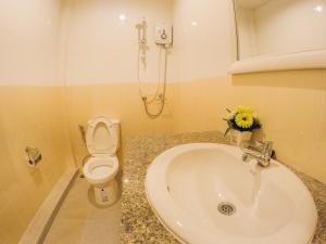 a bathroom with a sink and a toilet at Madam House in Karon Beach
