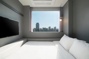 Postel nebo postele na pokoji v ubytování Hotel Cappuccino