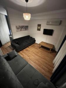a living room with a couch and a tv at Nehir Apart Hotel in Fethiye