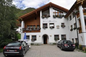 two cars parked in front of a building at Chasa Val Bella in Samnaun