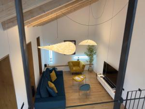 a living room with a blue couch and a television at Casa Gafura in Noya