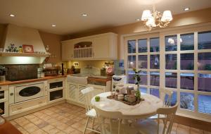 a kitchen with a table and chairs in a room at Slow living beautiful villa in Rafina