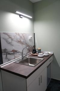 a kitchen with a sink and a counter top at Sweet Studios Kavala in Kavála