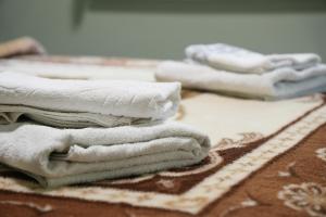 a pile of white towels sitting on top of a rug at Sweet Studios Kavala in Kavála