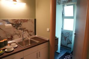 a kitchen with a sink and a counter top at Sweet Studios Kavala in Kavála