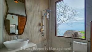a bathroom with a sink and a large window at Epic Views Cabins - Ocean or Mountains, your choice in Ko Phangan +73 photos