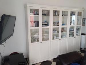 a white cabinet in a living room with a tv at Exceptionnelle vue front de mer avec accès direct plage in Saint Malo