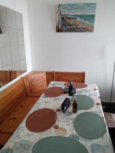a table with wine bottles and glasses on it at Exceptionnelle vue front de mer avec accès direct plage in Saint Malo