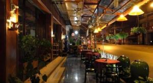 a restaurant with tables and chairs in a building at Panorama Hotel in Mae Hong Son