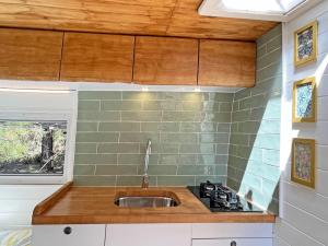 een keuken met een spoelbak en een fornuis bij Glamping converted van with bathroom in Los Cristianos +4 foto's