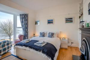 a bedroom with a bed and a large window at 5 Bed in Mumbles oc-l34618 in The Mumbles