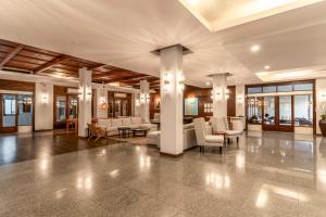 a lobby with couches and chairs in a building at Sunprime Kamala Beach in Kamala Beach +102 photos