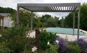 a garden with a fire hydrant and a swimming pool at Le Jardin des Oiseaux in Saint-Michel-sur-Loire