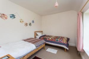 a bedroom with two beds and a window at 3 Bed in Ampleforth oc-m34673 in Ampleforth