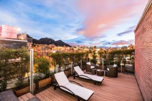 a balcony with chairs and a view of a city at Hotel Cabrera Imperial By key 33 in Bogotá