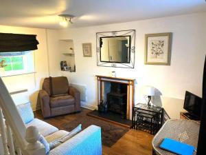 a living room with a couch and a fireplace at 1 Bed in Ampleforth oc-b34674 in Ampleforth