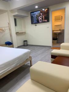 a room with a bed and a tv on the wall at Uncle Yo House in Ban Tha Khreng +9 photos