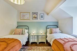 a bedroom with two beds and a table with candles at 3 Bed in Neath oc-p34366 in Neath