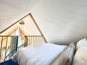 a bed in a room with a large window at Namelis su sauna SMILGA in Radailiai +10 photos
