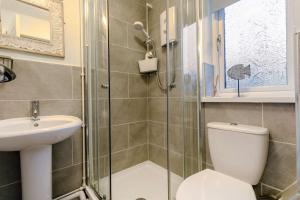 a bathroom with a shower and a toilet and a sink at 2 Bed in Penzance oc-m27232 in Gulval +13 photos