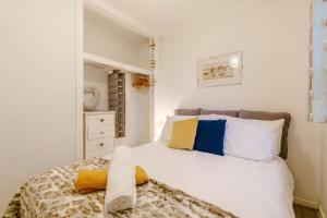 a bedroom with a white bed with blue and yellow pillows at 2 Bed in Penzance oc-m27232 in Gulval