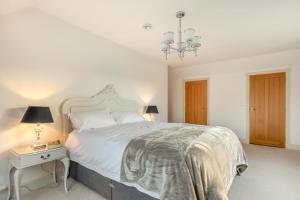 a white bedroom with a large bed and a table at 2 Bed in Duddlestone oc-q34588 in Duddlestone