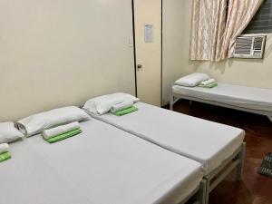 a hospital room with two beds and a window at Mybed Dormitory in Cebu City