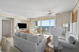 a living room with two couches and a television at Indigo West 1404 in Perdido Key
