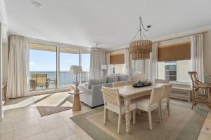 a living room with a table and a couch at Indigo West 1404 in Perdido Key