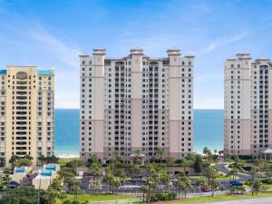 a large building with the ocean in the background at Indigo West 1404 in Perdido Key