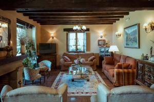 a living room with couches and a table at Posada San Pelayo in Camaleño