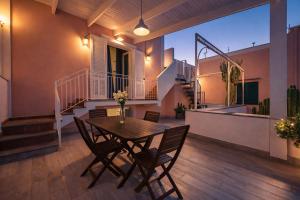 a dining room with a table and chairs on a house at Gioia 13 Rooms & Apartments in Procida