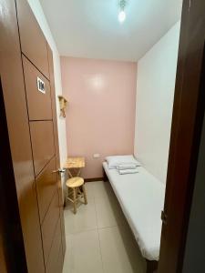 a small room with a bed and a chair at Mybed Dormitory in Cebu City +17 photos