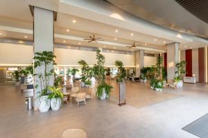 a lobby with a lot of potted plants at Swiss-Grand Beach Resort Kuantan - Newly Upgraded 5-Star in Kuantan +44 photos