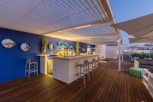 a kitchen with a bar on a deck at Hotel Baltum in Albufeira