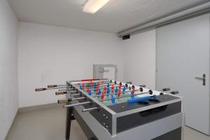 a room with a table with red and blueools at Titlis Studio Engelberg with Balcony great View in Engelberg +19 photos