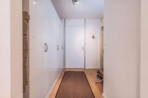 a room with white cabinets and a rug at Titlis Studio Engelberg with Balcony great View in Engelberg