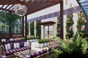 an outdoor patio with purple furniture and plants at Vivanta Gurugram Sector 95A in Gurgaon