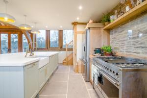 a kitchen with white cabinets and a stove top oven at 3 Bed in Dulas oc-g34082 in Longtown +34 photos