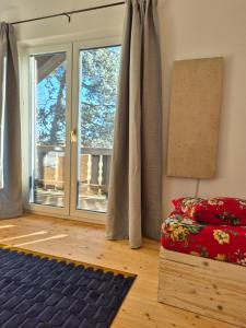 a living room with a bed and a window at The Staffelsee Lodge in Uffing