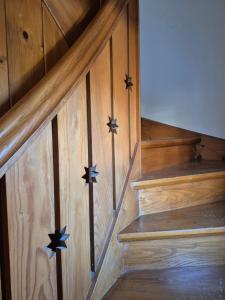 a wooden staircase with stars on the wooden wall at The Staffelsee Lodge in Uffing