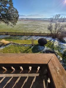 a wooden deck with a view of a field at The Staffelsee Lodge in Uffing