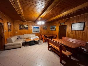 a living room with a couch and a table at Agro Ranczo - Domek na wynajem in Przysietnica