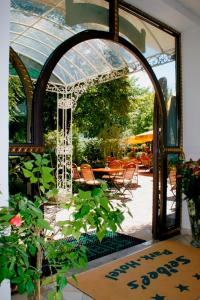an open door to a patio with a table and chairs at Seibel's Park Hotel in Munich