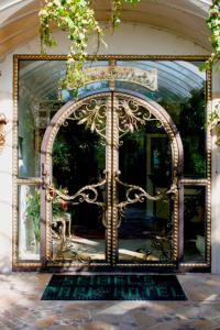 an ornate door to a house with a mirror at Seibel's Park Hotel in Munich