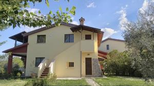a large white house with a roof at Agriturismo La Torriola in Todi