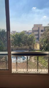 a balcony with a view of a building at فيلا كامله للايجار in Kafr Ghaţāţī